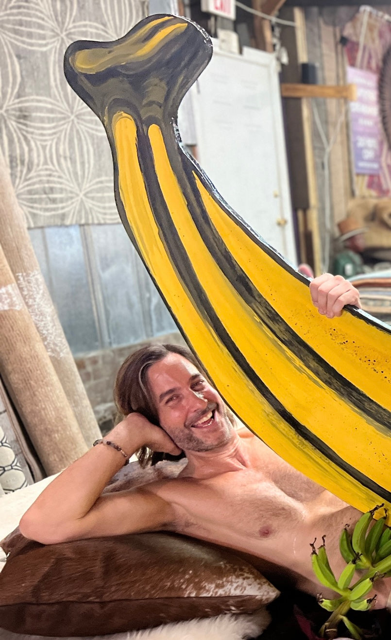 Naked Banana Manor guy holding large banana